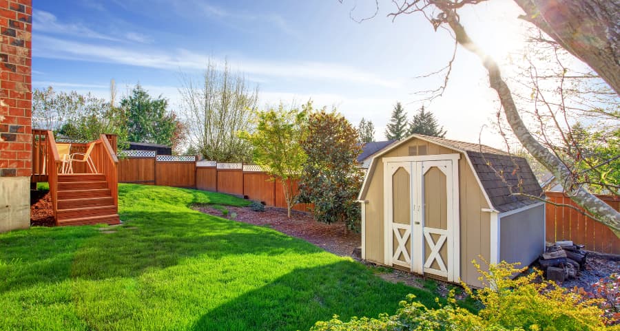 Fenced backyard with storage shed in Topeka