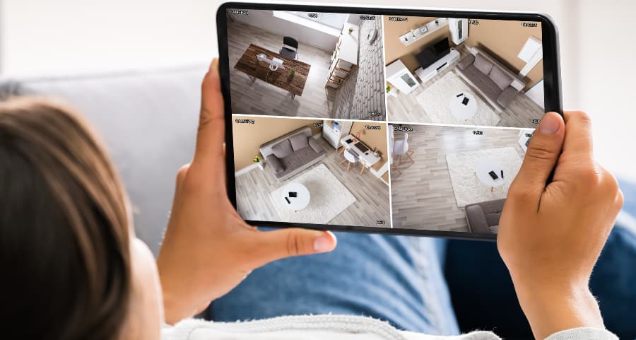 Homeowner checking security camera footage on mobile device